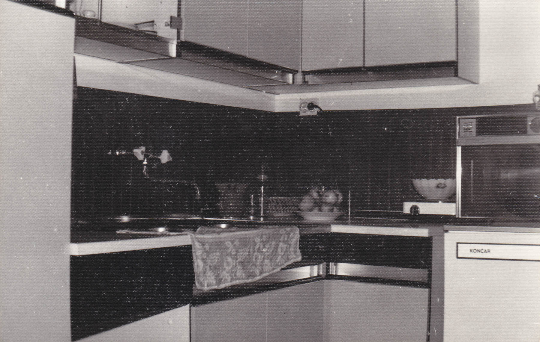 The oldest photo of it that I could find. This is actually the whole kitchen as of june 1981; the microwave is the thing on the fridge.
