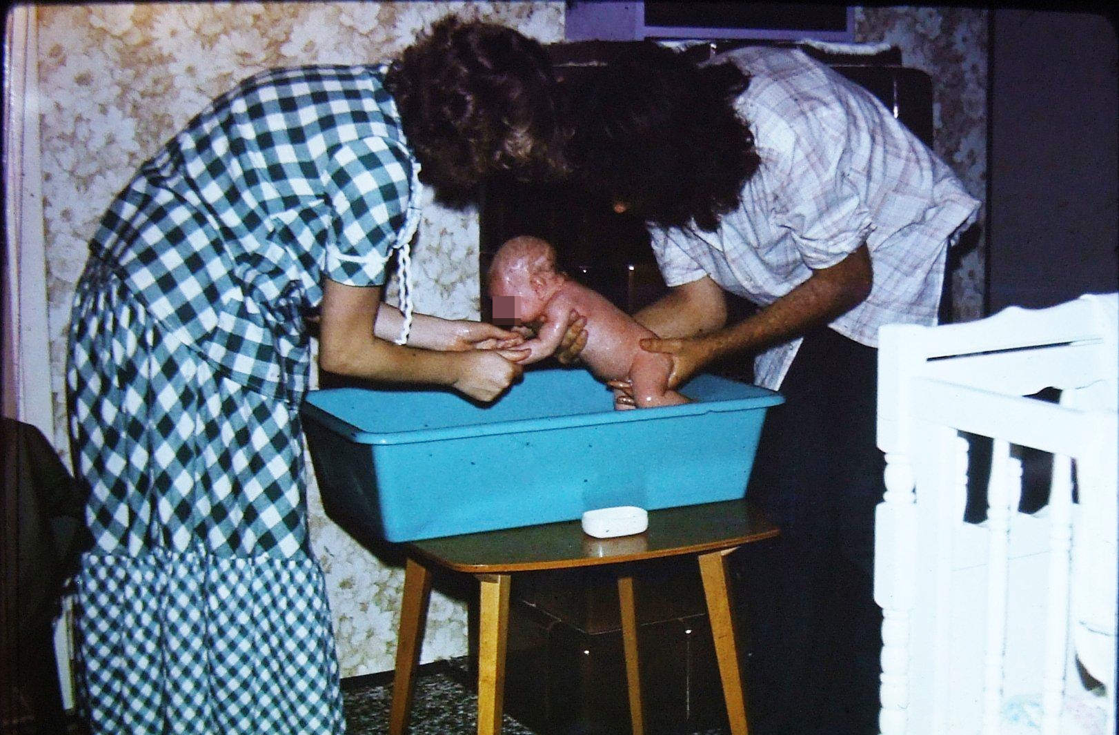 The baby bed held for 14 years. The terrace table, from the Rex chairs set, is still in use. The purple frame above my back is the left speaker.